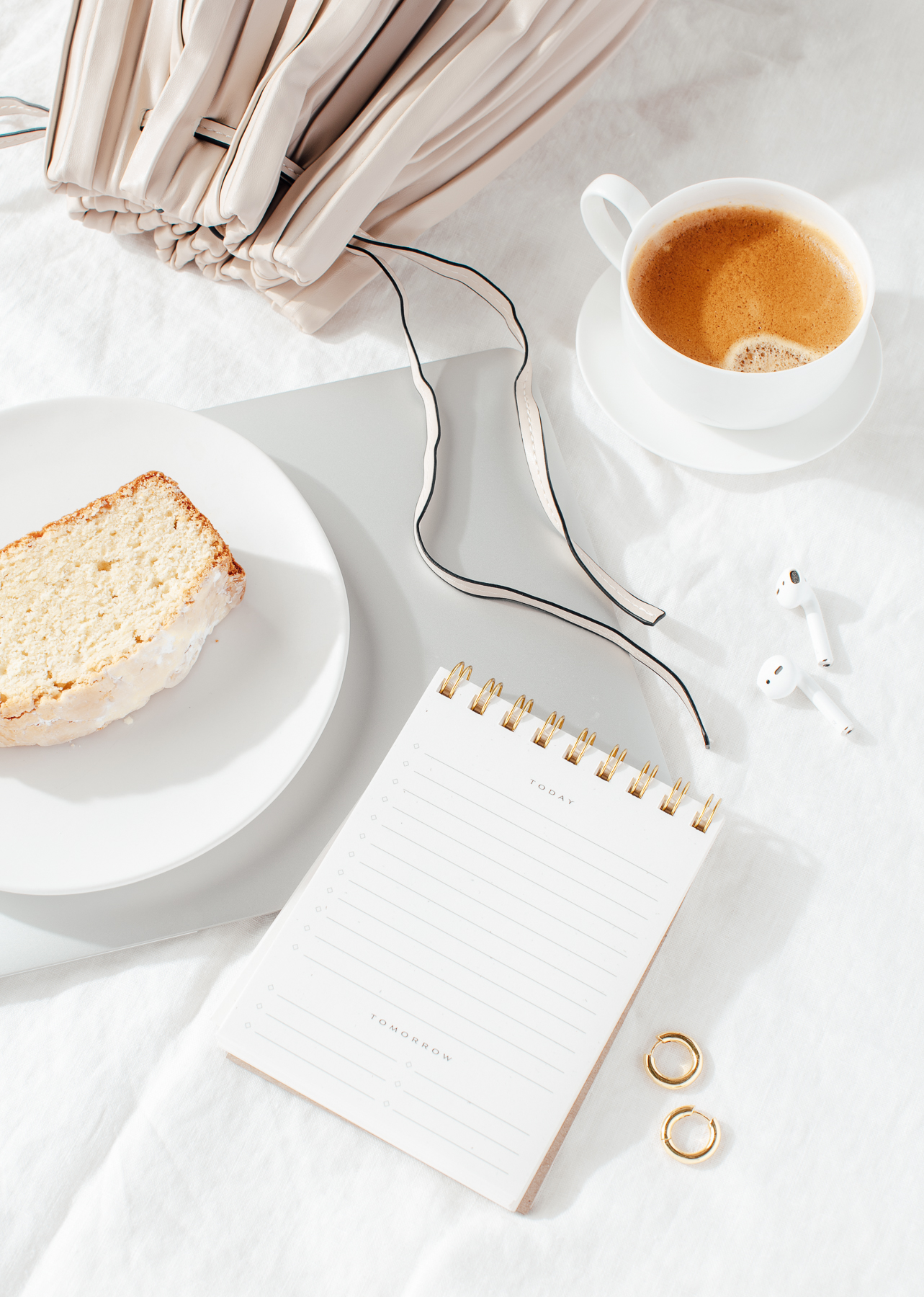 coffee and cake flatlay featuring a notebook